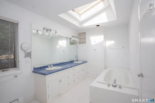 a bathroom with a granite countertop sink a toilet and shower