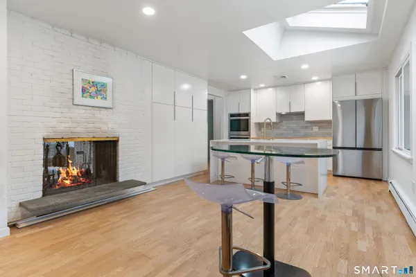 a kitchen with kitchen island a counter top space a sink stainless steel appliances and cabinets