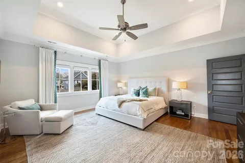a bedroom with a large bed and a chandelier