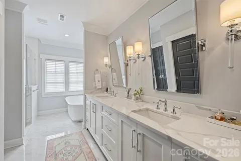 a bathroom with a granite countertop sink double vanity and a mirror