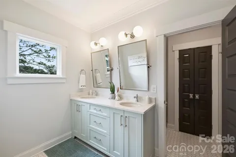 a bathroom with a sink vanity and mirror