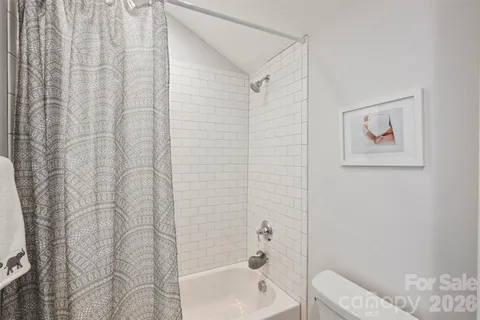 a bathroom with a toilet and shower