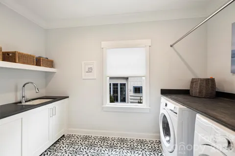 a kitchen with a sink and a stove top oven