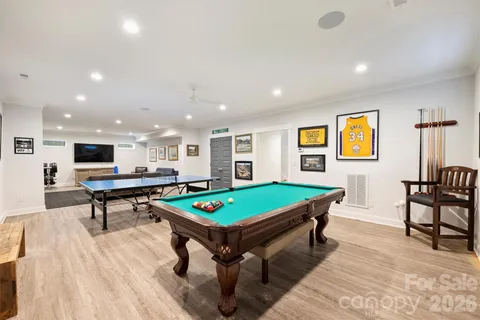 a living room with pool table and a table