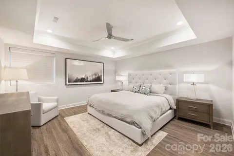 a bedroom with a large bed and a chandelier