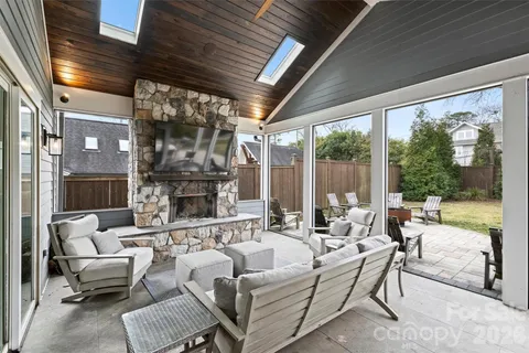 a living room with fireplace furniture and a large window