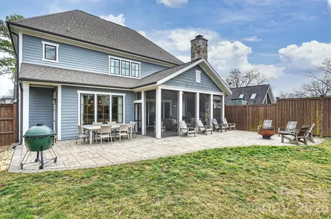 a backyard of a house with table and chairs