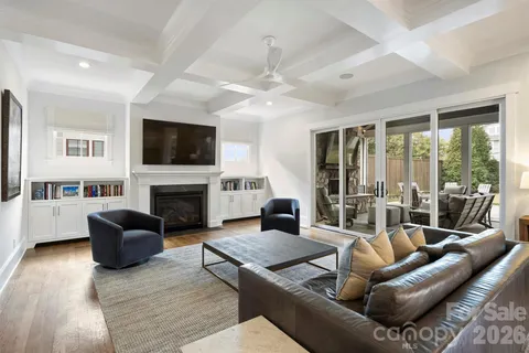 a living room with furniture fireplace and flat screen tv