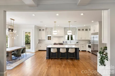 a large kitchen with a table and chairs in it