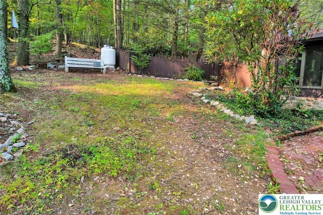 a backyard of a house with a patio and outdoor seating