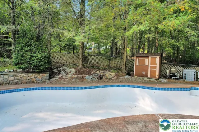 a view of a house with backyard sitting area and garden