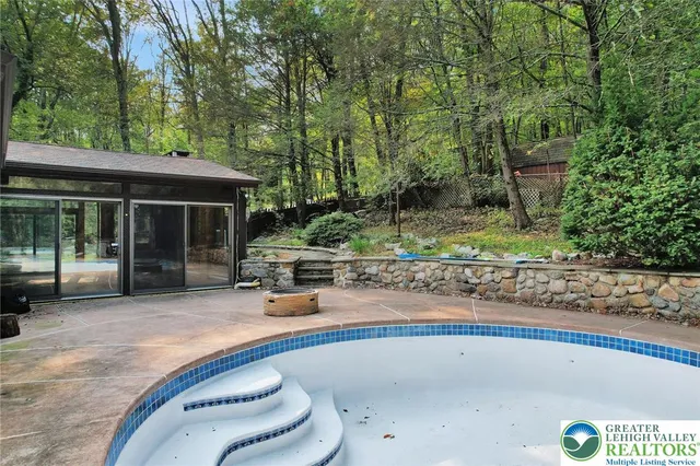 a front view of a house with yard and green space