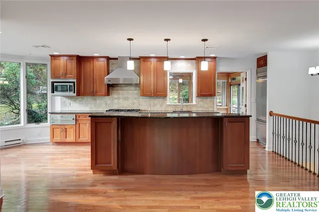a view of a kitchen counter space a sink a window and stainless steel appliances