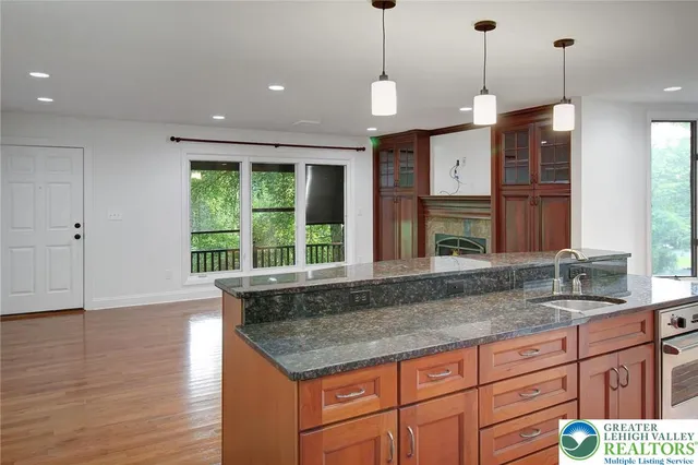 a kitchen with a sink a counter top space and stainless steel appliances