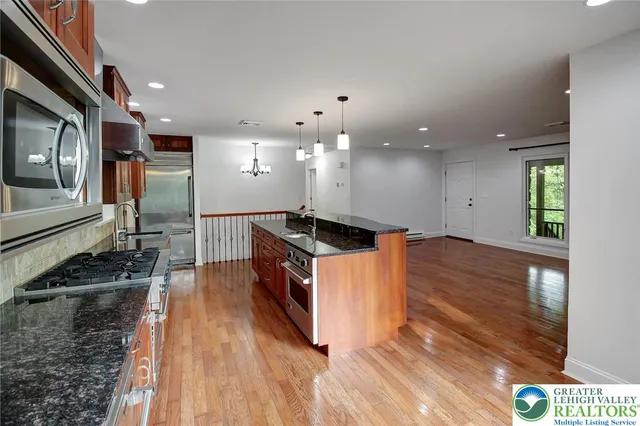 a view of a stove with wooden floor