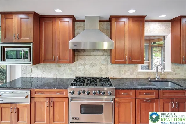 a stove top oven sitting inside of a kitchen