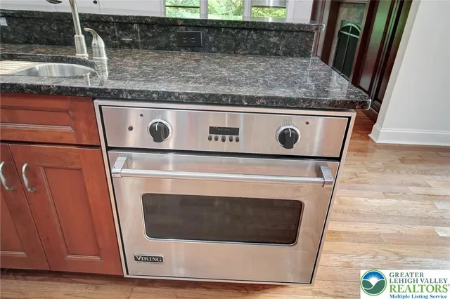 a kitchen with granite countertop a sink and a stove
