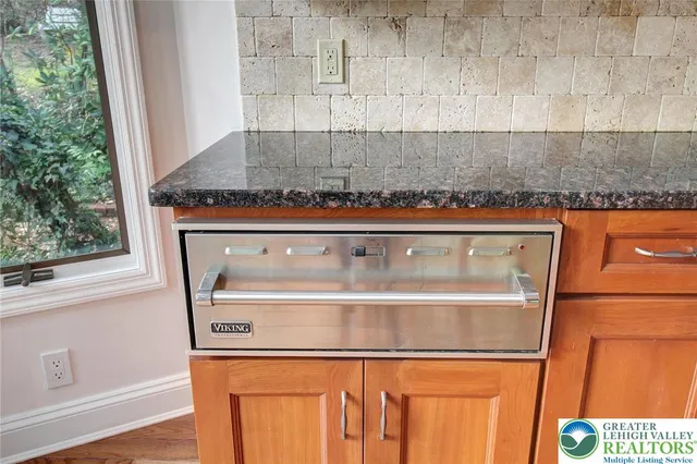 a kitchen with granite countertop a sink a stove and granite counter tops