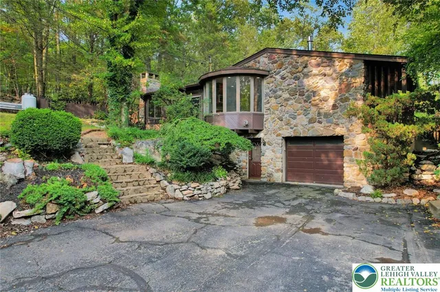 a front view of a house with a yard and a garage