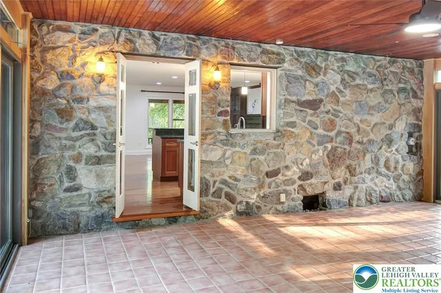 a view of a small space with wooden floor and a window