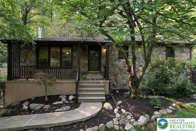 a view of a house with backyard outdoor seating and green space