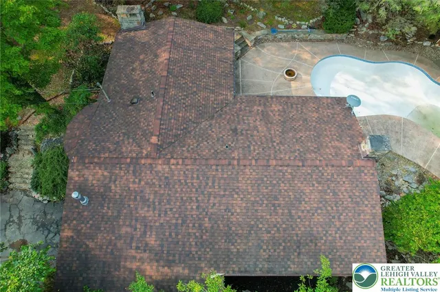 an aerial view of a house with a yard