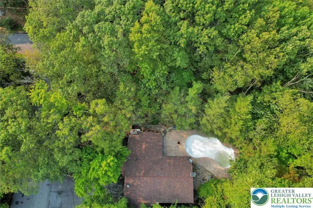 an aerial view of a house with a yard and garden