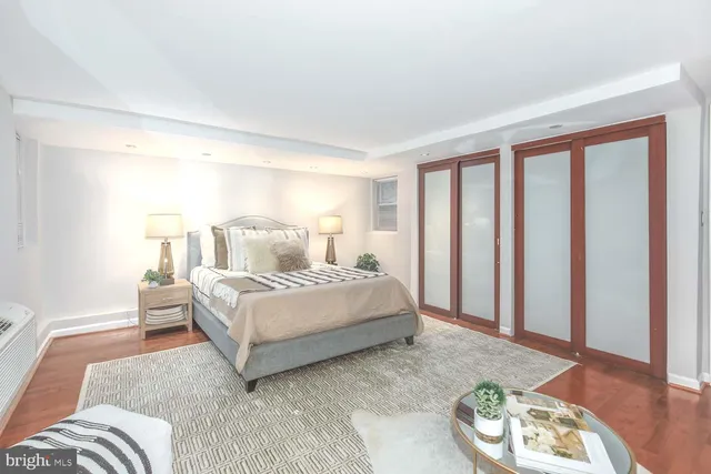 a bedroom with a bed and a couch