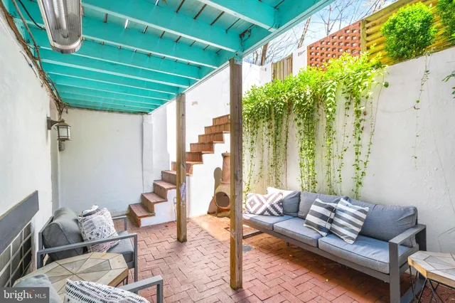 a outdoor living space with furniture and a potted plant