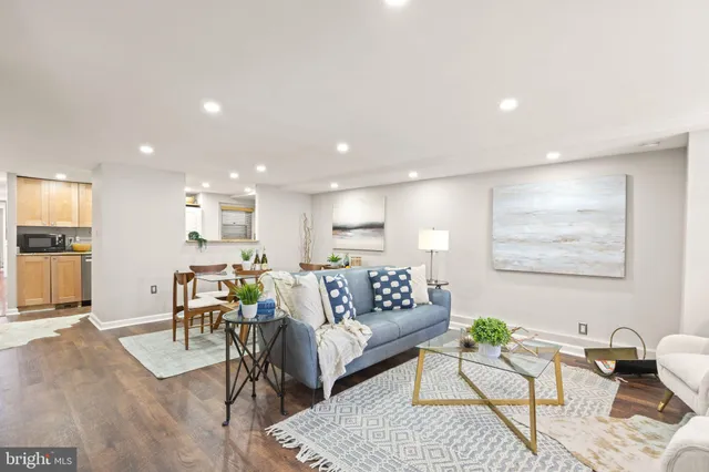 a living room with furniture and kitchen view