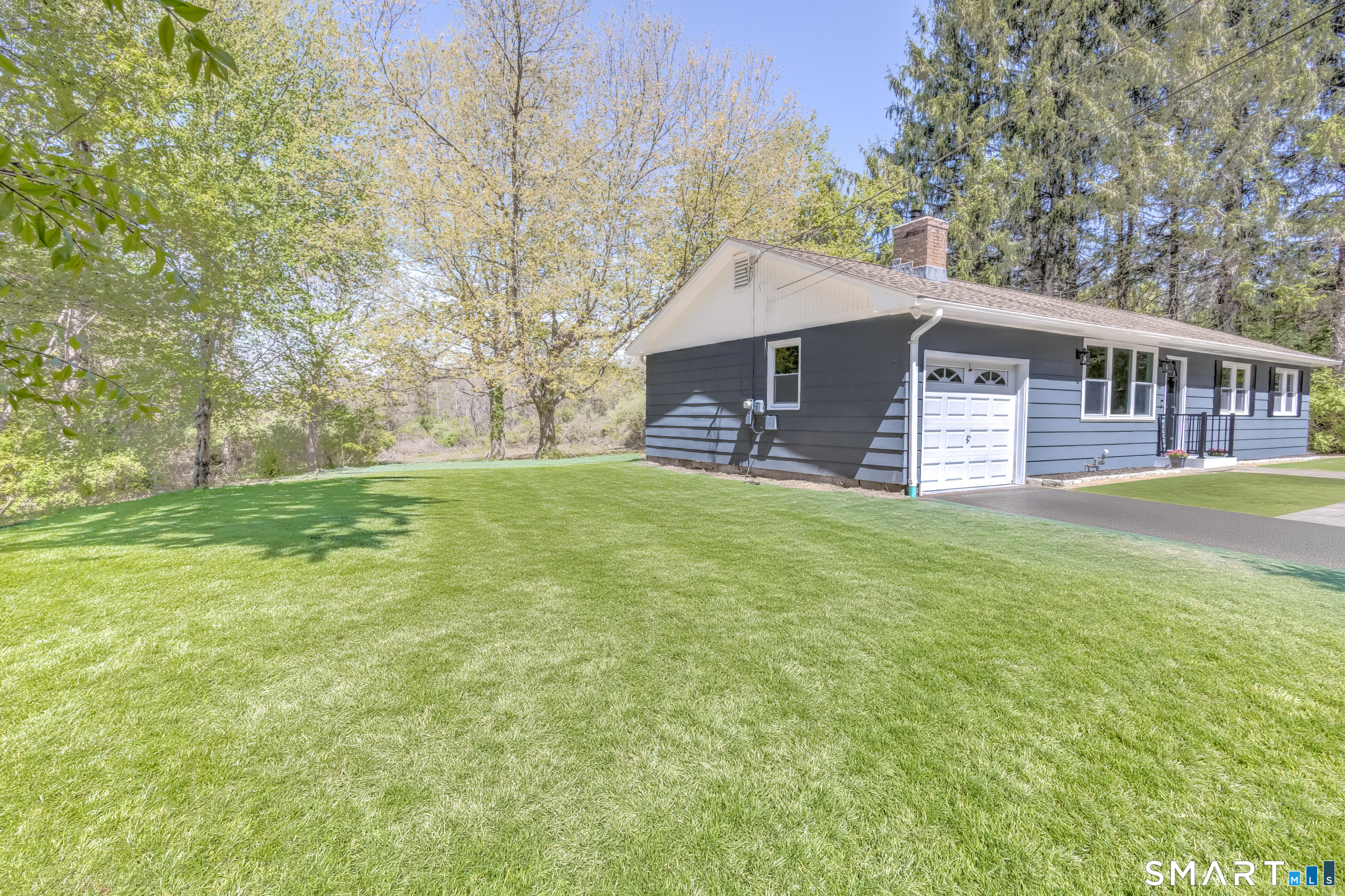 437 Middle Rd Turnpike Woodbury, CT 06798 - Photo 15 of 17 a backyard of a house with yard and outdoor seating