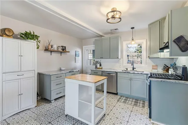 a kitchen with a sink stove and cabinets