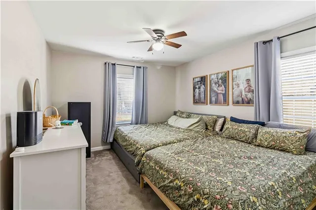 a bedroom with a bed and dresser with mirror