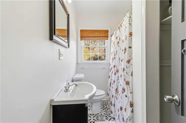 a bathroom with a sink a mirror and a shower