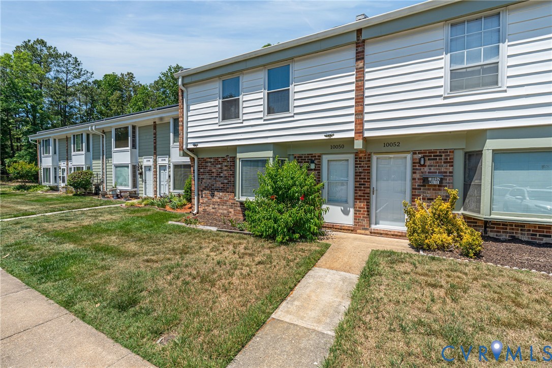10050 Purcell Road Richmond, VA 23228 - Photo 2 of 26 a front view of a house with a garden and patio