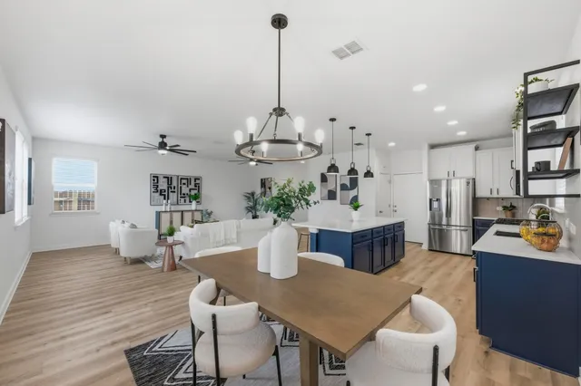 a dining room with furniture and wooden floor