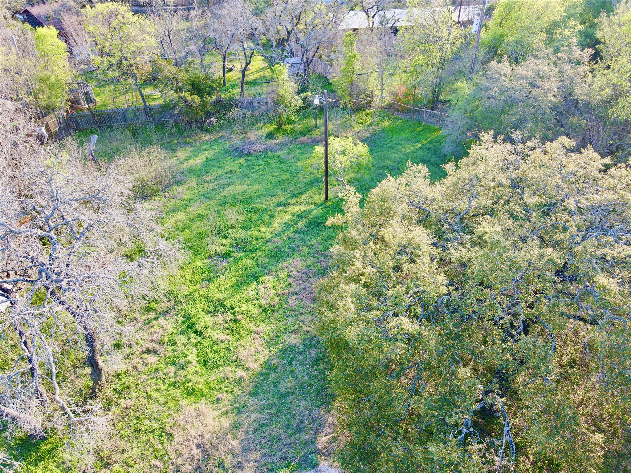 18311 Spring Lane Jonestown, TX 78645 - Photo 5 of 11 a backyard of a house with a yard and outdoor seating