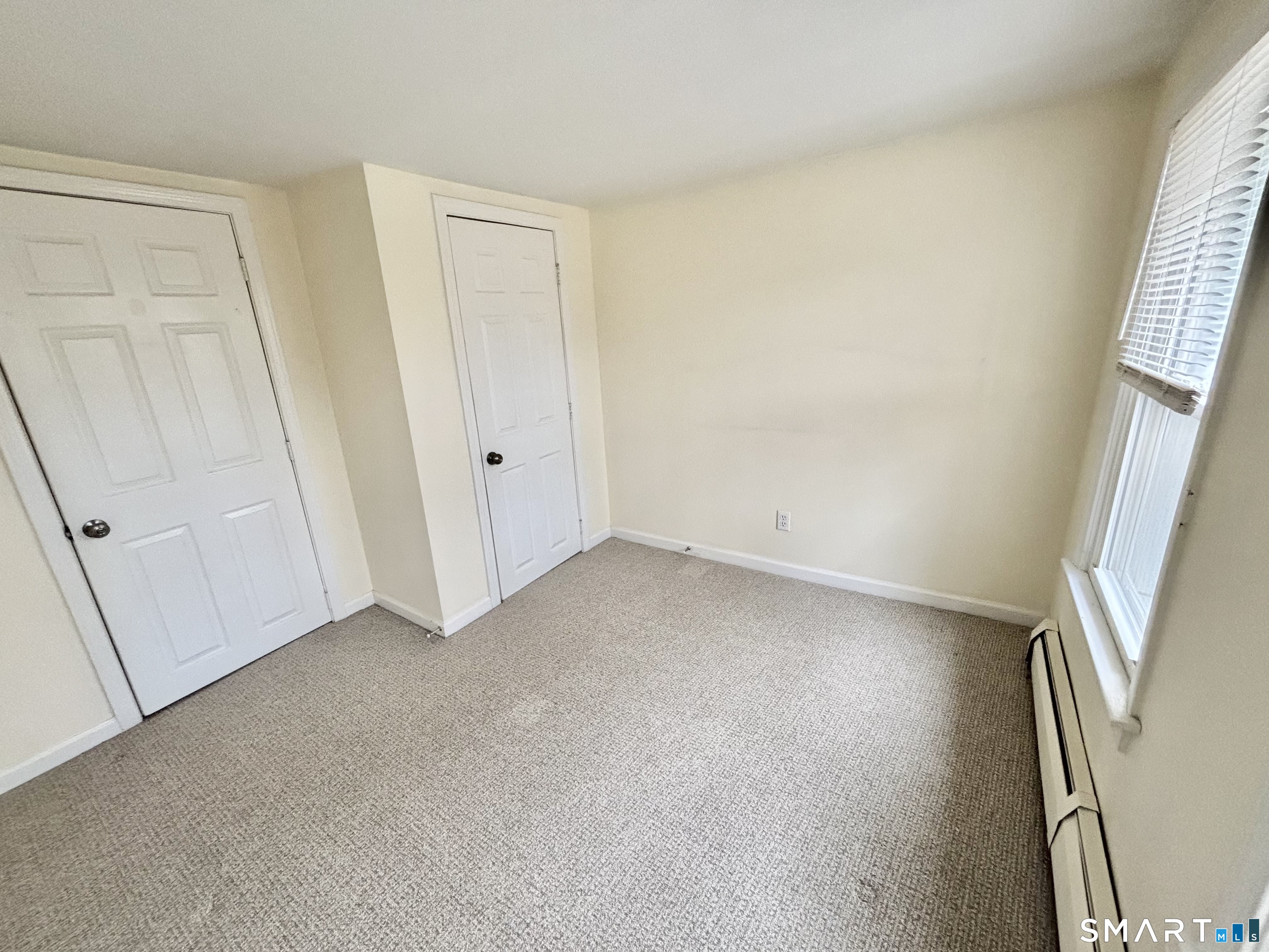 61 Scotland Avenue, Unit NORTH Madison, CT 06443 - Photo 12 of 19 an empty room with windows