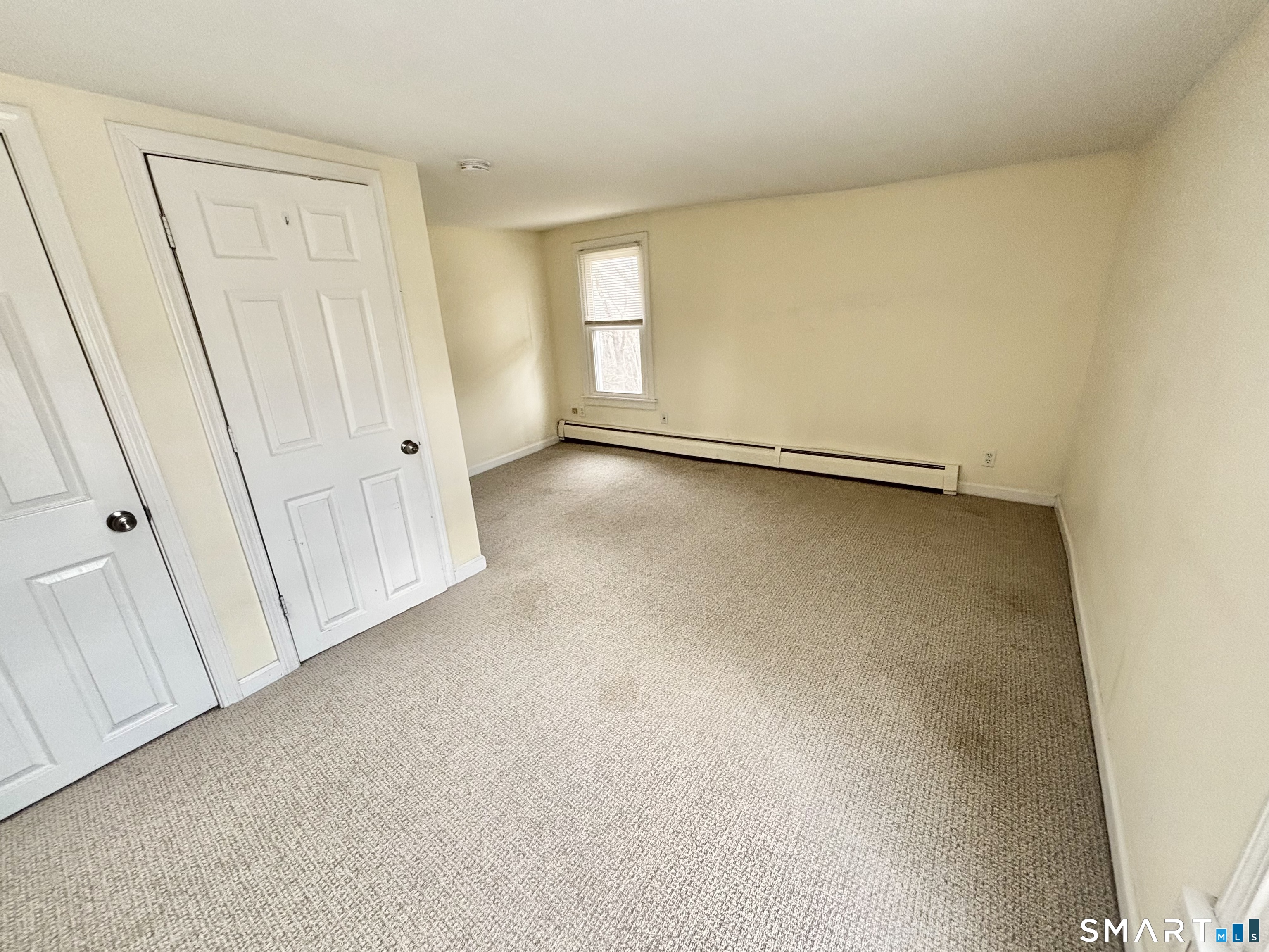 61 Scotland Avenue, Unit NORTH Madison, CT 06443 - Photo 15 of 19 an empty room with a door