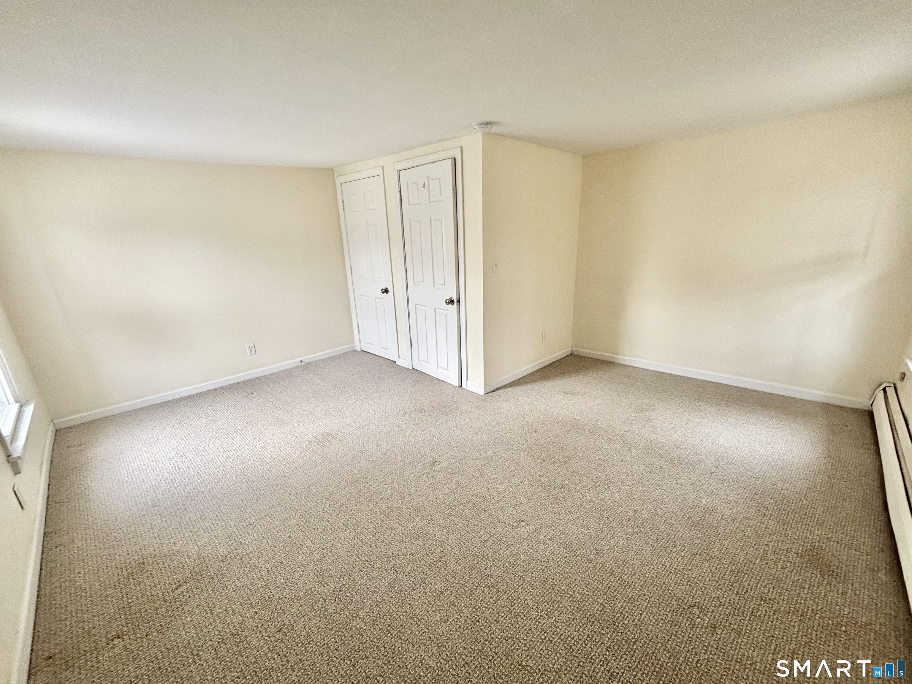 61 Scotland Avenue, Unit NORTH Madison, CT 06443 - Photo 16 of 19 an empty room with a natural light