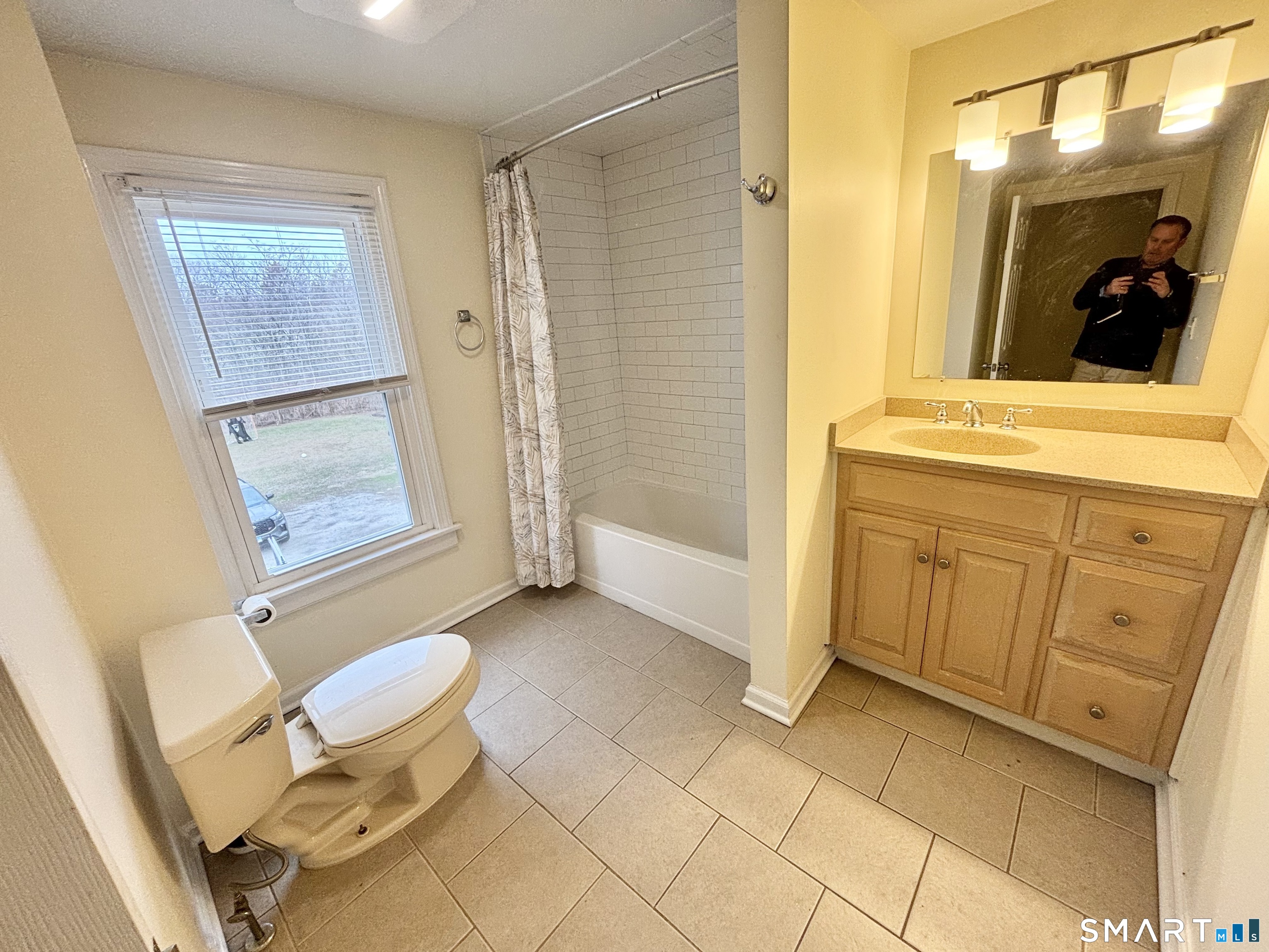 61 Scotland Avenue, Unit NORTH Madison, CT 06443 - Photo 17 of 19 a bathroom with a granite countertop sink a mirror and a shower
