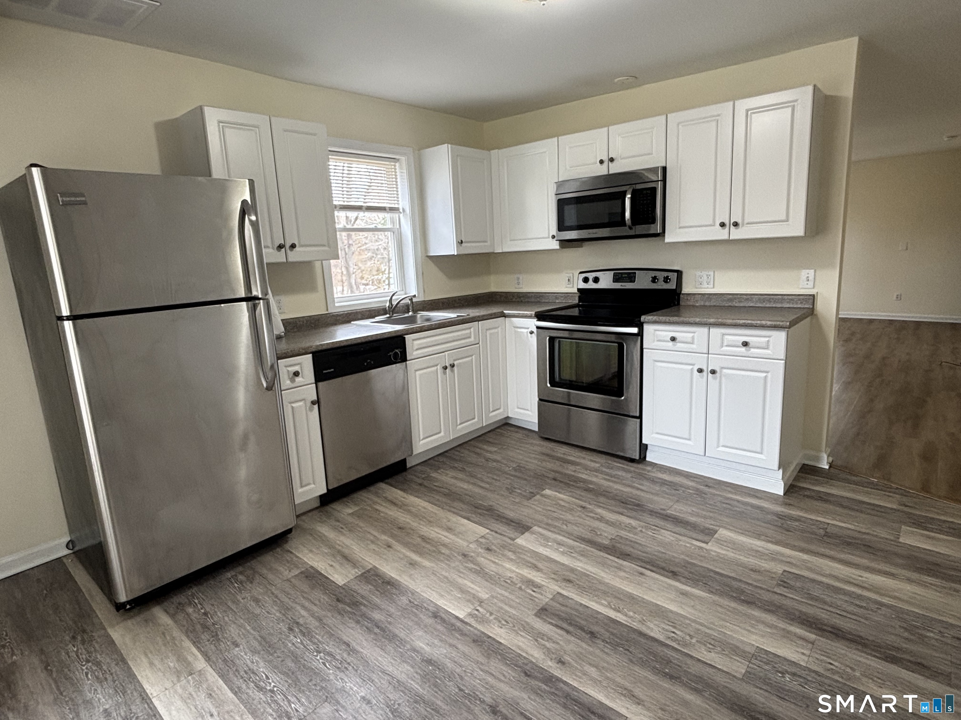 61 Scotland Avenue, Unit NORTH Madison, CT 06443 - Photo 5 of 19 a kitchen with granite countertop a refrigerator stove and microwave