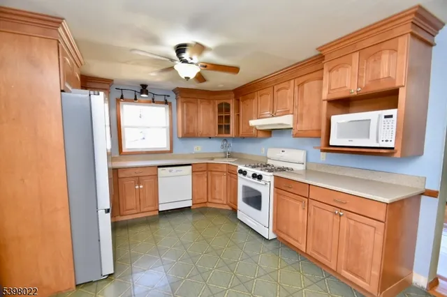 a kitchen with stainless steel appliances granite countertop a sink and cabinets
