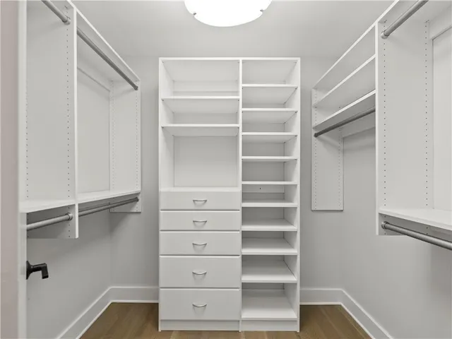 a view of walk in closet with empty racks