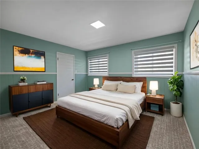 a bedroom with a bed and a potted plant