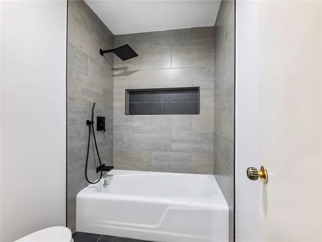 a bathroom with a tub and a sink