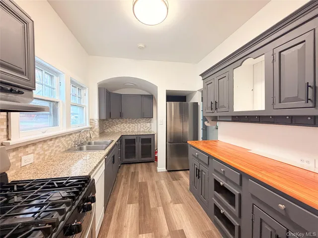 a kitchen with stainless steel appliances granite countertop a stove and a sink