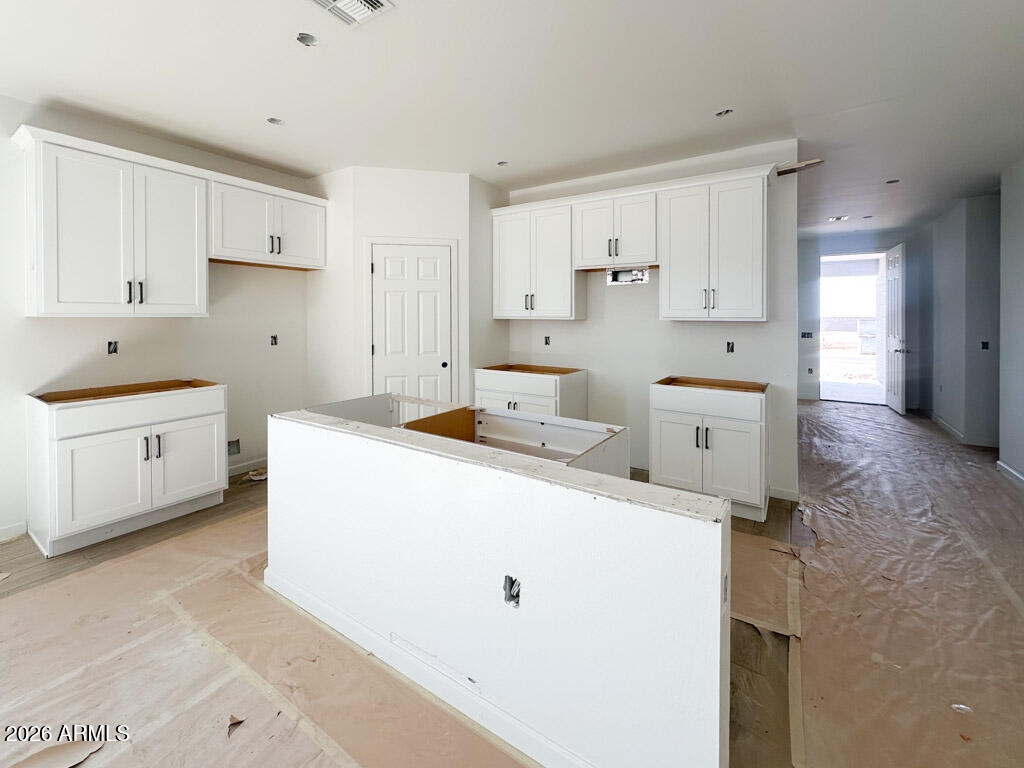 46953 North Dry Gulch Road Maricopa, AZ 85139 - Photo 3 of 16 a large white kitchen with cabinets and a refrigerator