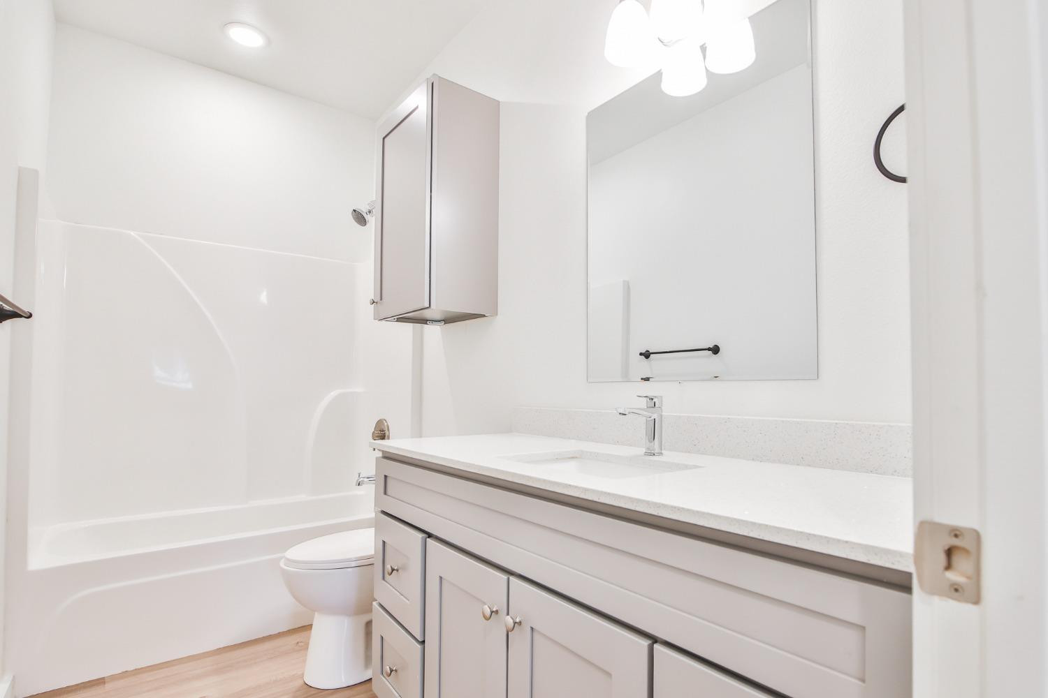 5508 Itasca Street Lubbock, TX 79416 - Photo 12 of 25 a bathroom with a sink a toilet and bathtub