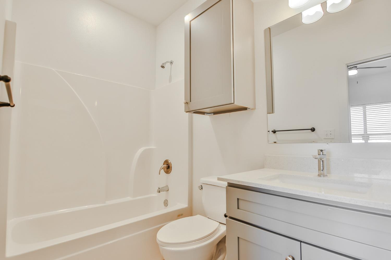 5508 Itasca Street Lubbock, TX 79416 - Photo 17 of 25 a bathroom with a sink a toilet and shower